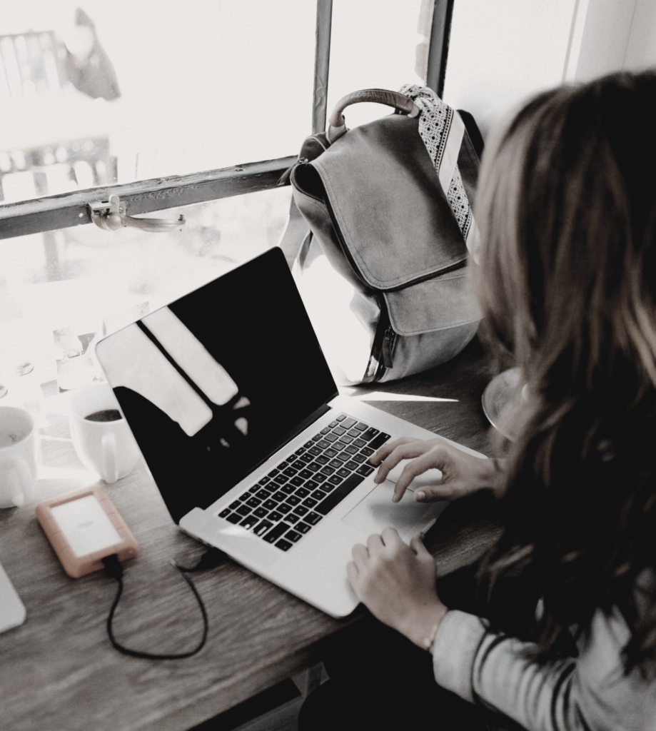 woman writing on laptop