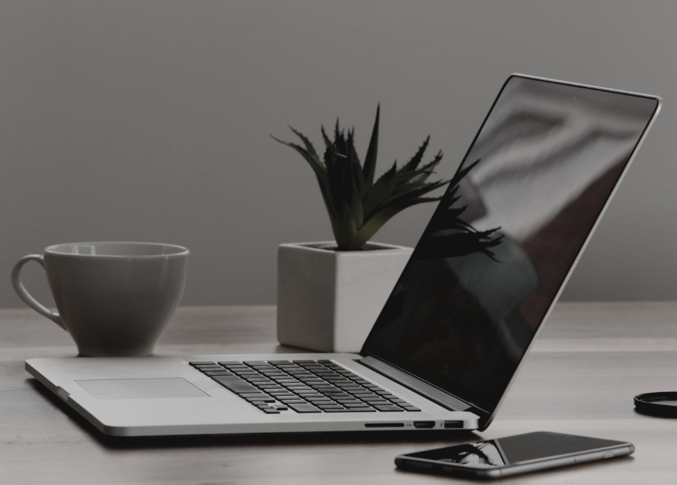 open laptop by coffee mug